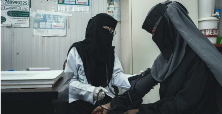 A health worker checks a patient's blood pressure at a clinic in Lahj Governorate, Yemen.